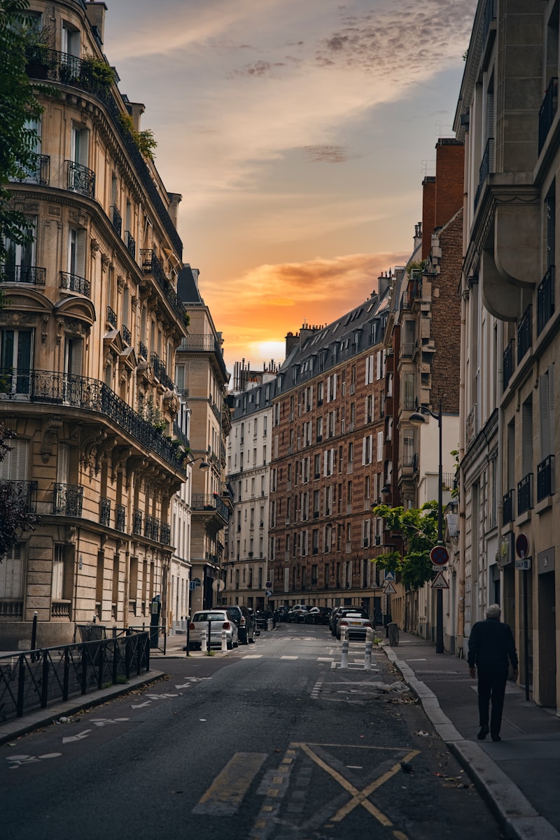 A parisian street glows during sunset.